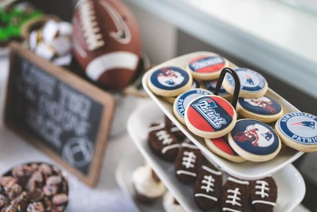 Cookies with football team logos and mini football shaped brownies.