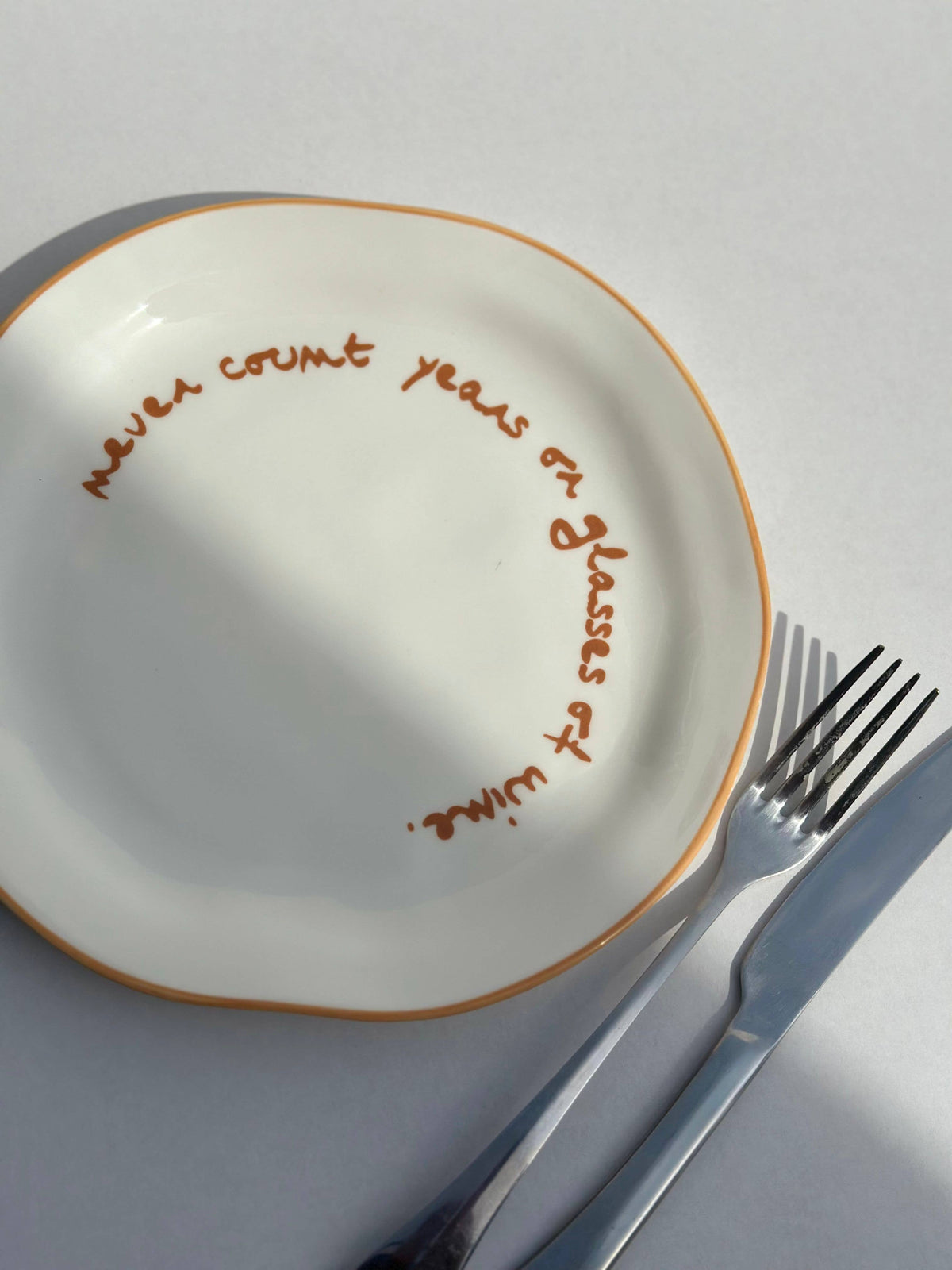 Statement Plate - 'never count years of glasses of wine.'