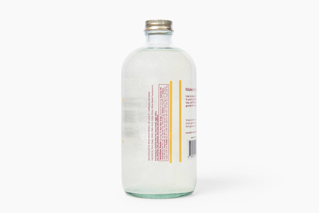 Clear glass bottle with a metal cap on a white background