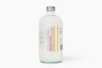 Clear glass bottle with a metal cap on a white background