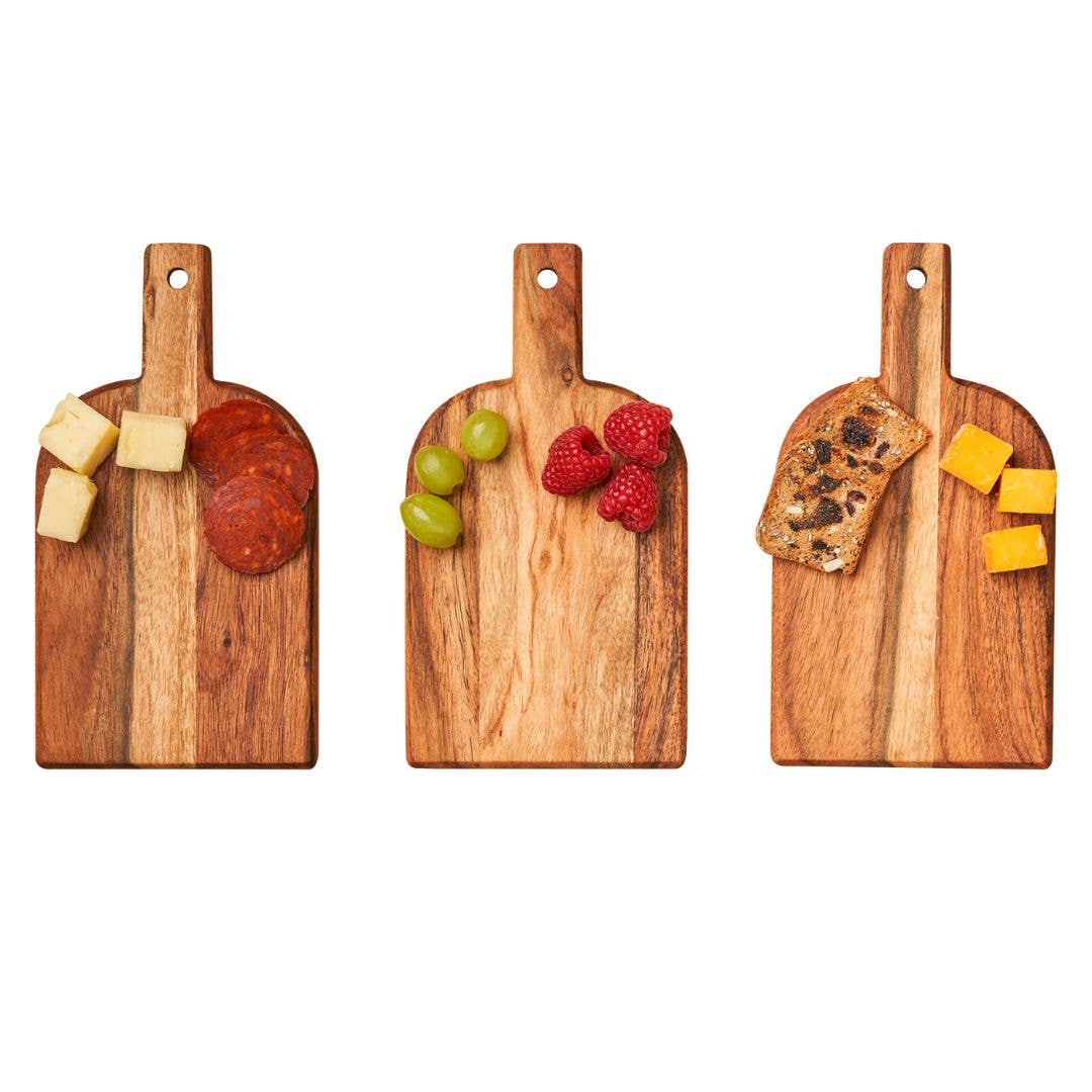 Three wooden cutting boards with various food items on a white background