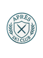 Logo of Après Ski Club with crossed skis and laurel leaves on a white background