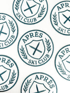 Repeating pattern of 'APRèS SKI CLUB' logos on a white background