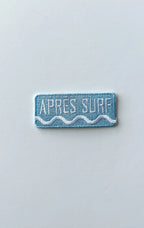 Rectangular patch with 'Apres Surf' text on a light gray background