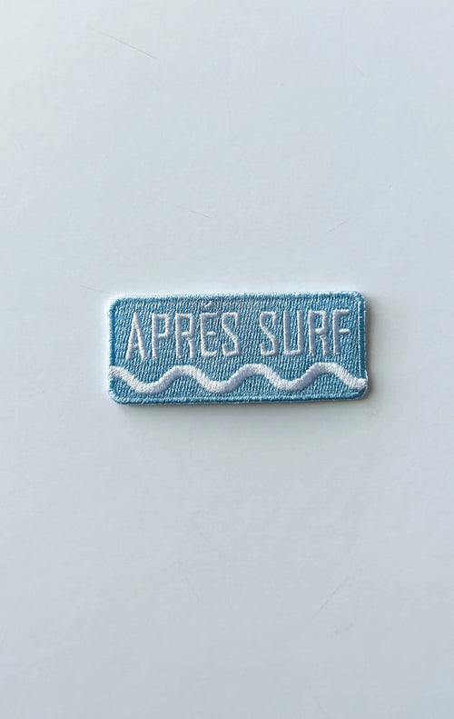 Rectangular patch with 'Apres Surf' text on a light gray background