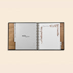 Open recipe book with wooden cover on a beige background