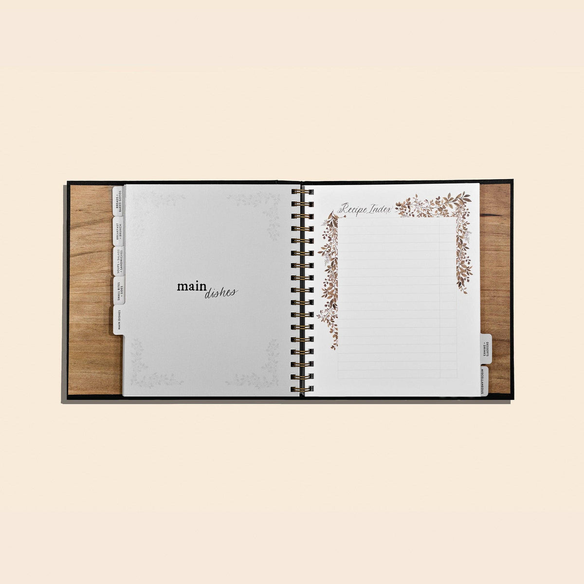 Open recipe book with wooden cover on a beige background