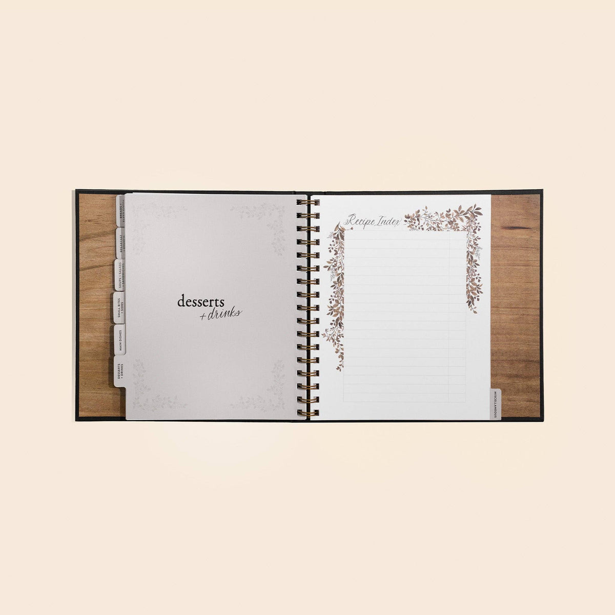 Open recipe book with 'desserts & drinks' section on a beige background