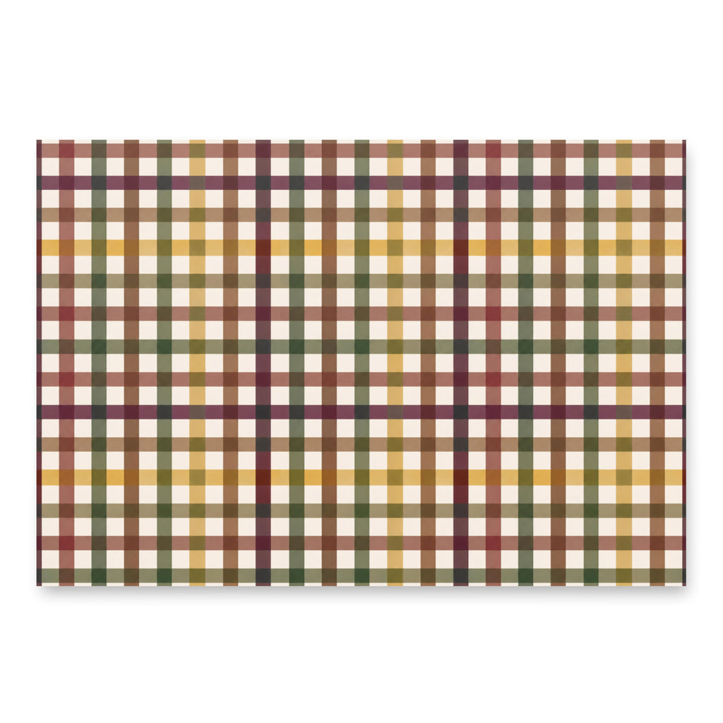 A rectangular plaid fabric or paper sample with a multicolor tartan pattern in cream, mustard yellow, olive green, burgundy, and brown, shown on a white background with a soft drop shadow.