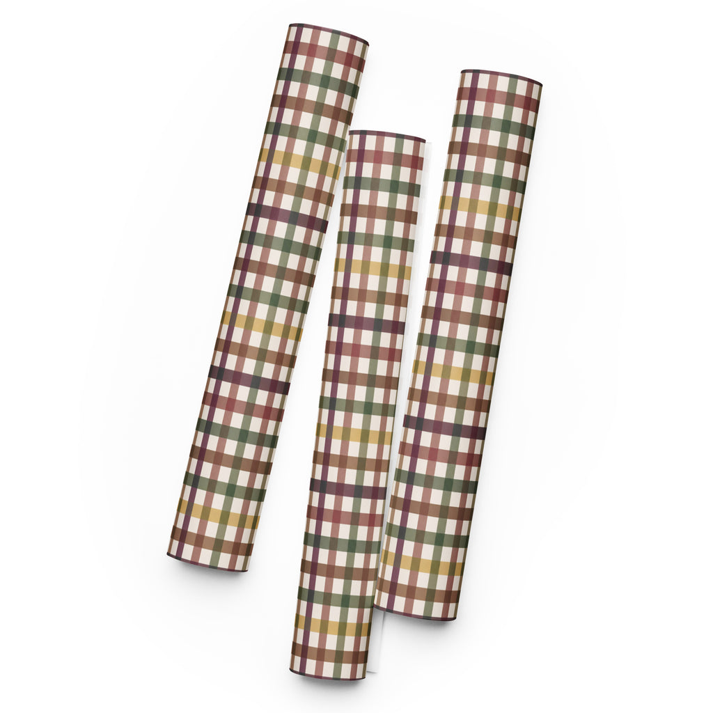 Three sheets of plaid wrapping paper rolled and standing upright on a white background. The wrapping paper features a multi-colored plaid pattern with intersecting stripes of brown, green, yellow, and white.