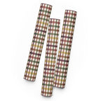 Three sheets of plaid wrapping paper rolled and standing upright on a white background. The wrapping paper features a multi-colored plaid pattern with intersecting stripes of brown, green, yellow, and white.