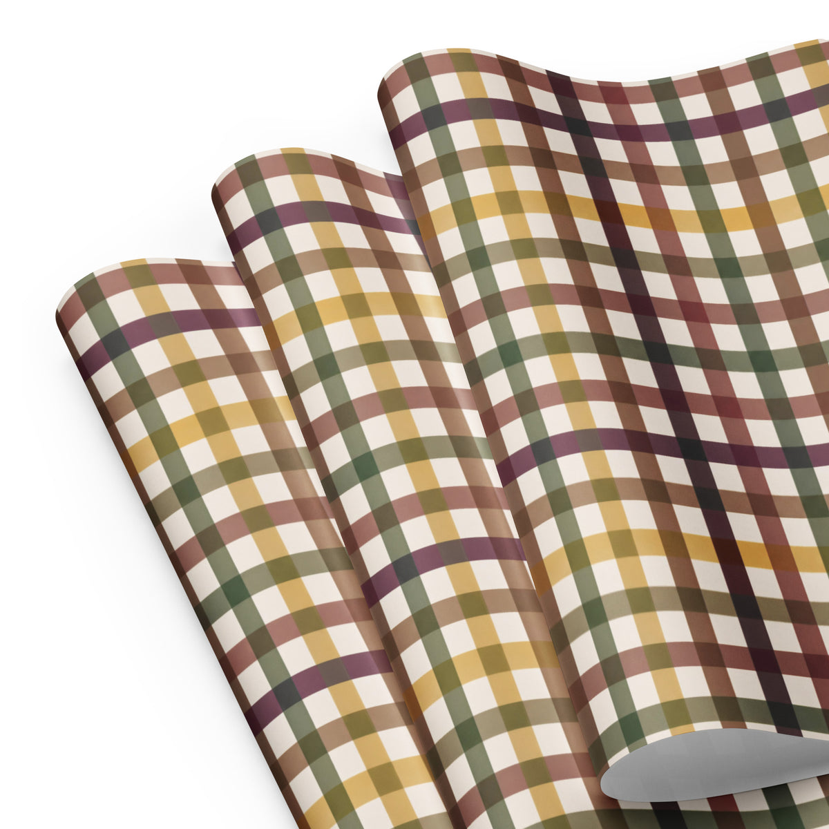 A roll of plaid wrapping paper or fabric shown partially unrolled on a clean white background. The pattern features intersecting stripes in mustard yellow, olive green, dark brown, and deep plum purple on an off-white base.