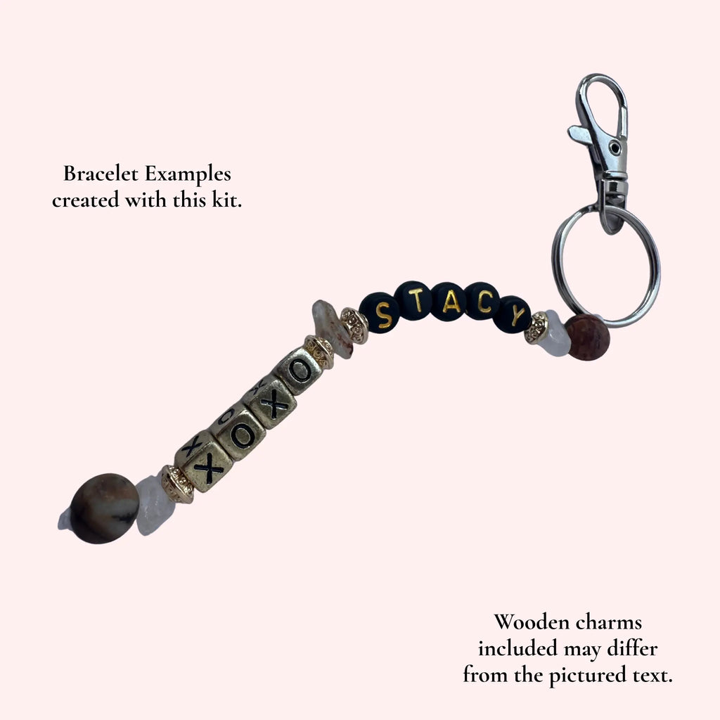A personalized beaded bracelet keychain with a silver clasp and split ring, featuring wooden letter charms spelling 'STACY' and 'XOXO', on a pale pink background with descriptive text overlays.