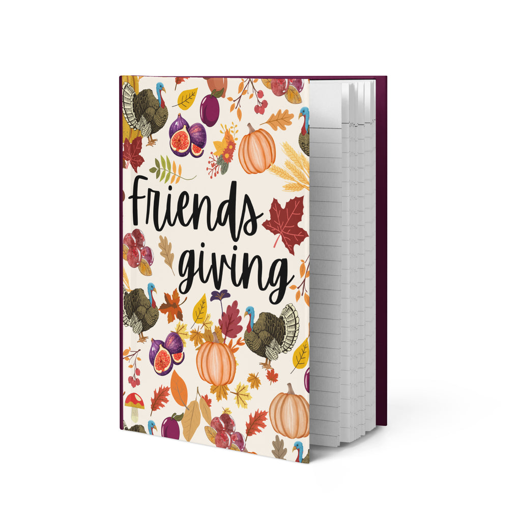 Notebook with 'Friendsgiving' design featuring pumpkins, turkeys, and leaves on a white background.
