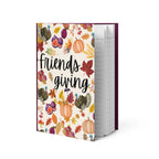 Notebook with 'Friendsgiving' design featuring pumpkins, turkeys, and leaves on a white background.
