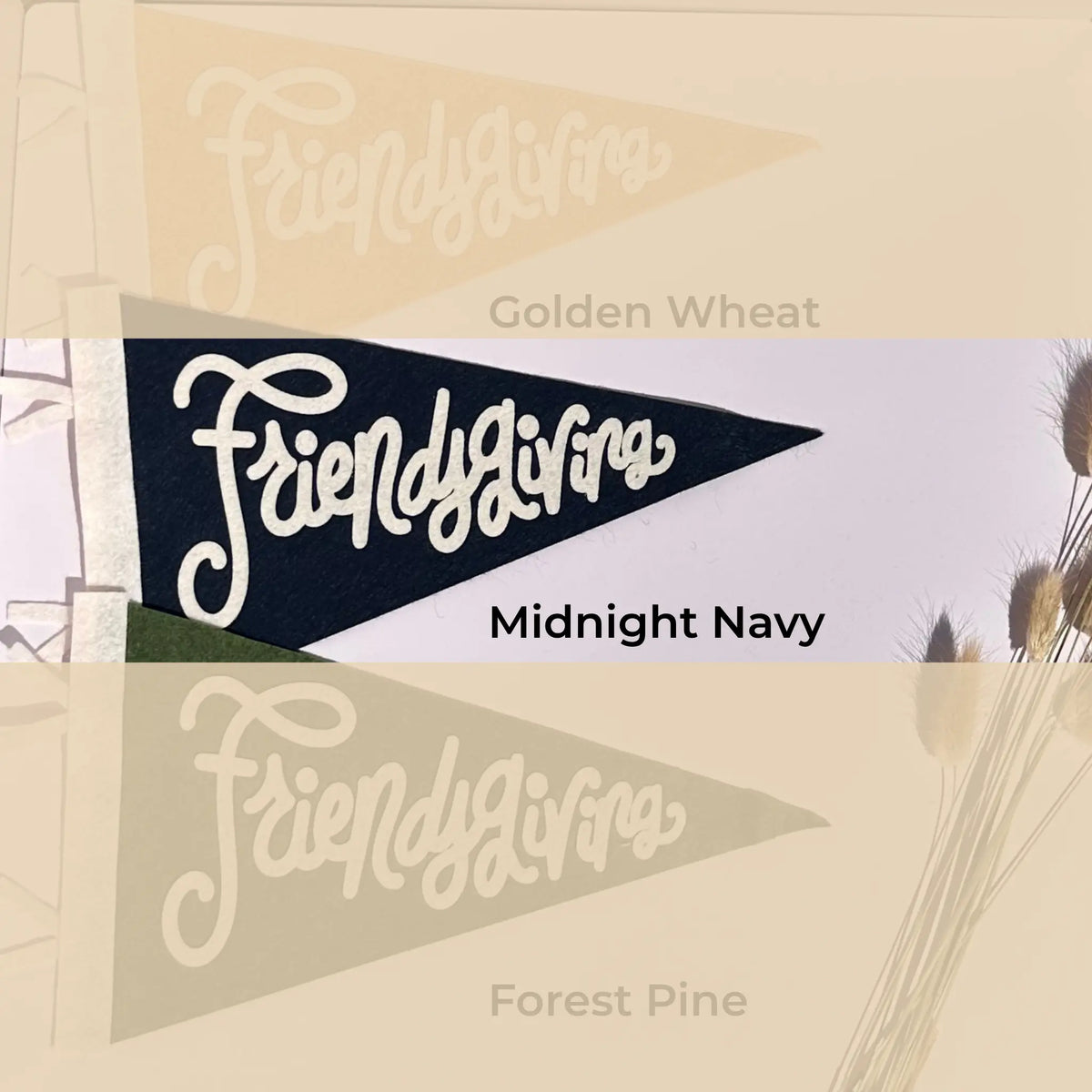 Three overlapping pennant flag designs labeled Friendlygivens, with color names Golden Wheat, Midnight Navy, and Forest Pine shown beneath them on a beige background with dried grass illustrations.