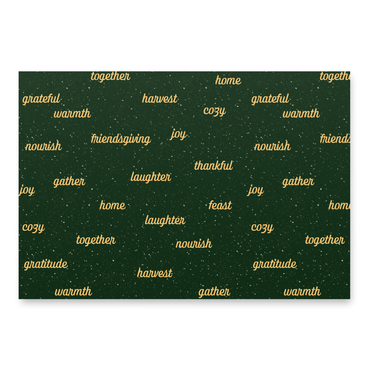 A square dark green fabric or paper product with a festive holiday pattern, featuring words like 'grateful', 'warmth', 'friendship', 'joy', 'harvest', and 'together' in gold script, accented with small white speckles. The item is shown flat against a clean white background with a subtle drop shadow.