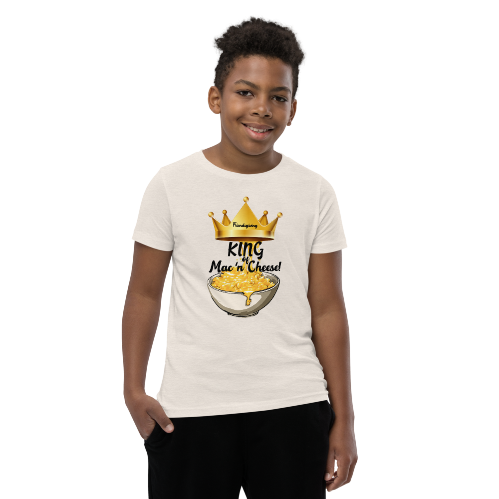 Child wearing a heather dust-colored white t-shirt with a cartoon character design on a white background