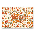 A rectangular decorative sign or print with an autumn Thanksgiving pattern, featuring the word 'FRIENDSGIVING' repeated in large orange script, surrounded by pumpkins, acorns, leaves, berries, and dots on a cream background.