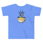 A light blue kids' t-shirt with a graphic print of a crown, the word 'Friendsgiving', and the text 'Prince  of Mac n' Cheese!' above an illustration of a bowl of macaroni and cheese.