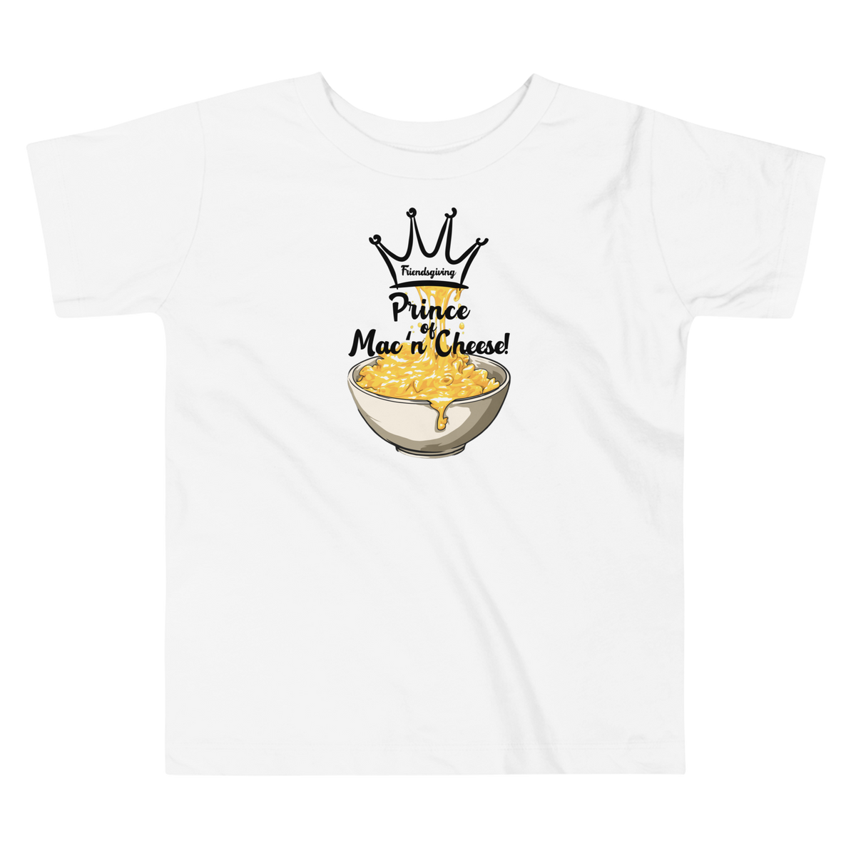 A white short-sleeve kids' t-shirt with a graphic print of a crown, the word 'Friendsgiving', and the text 'Prince of Mac 'n' Cheese!' above an illustration of a bowl of macaroni and cheese.
