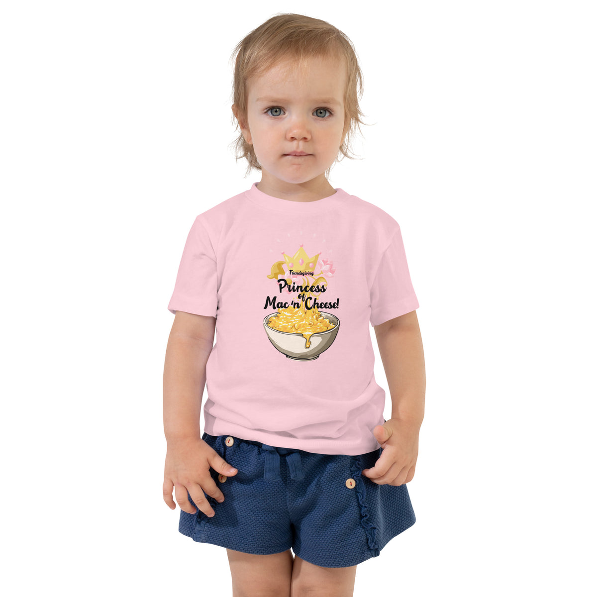 Child wearing a pink shirt with a colorful graphic design on a white background