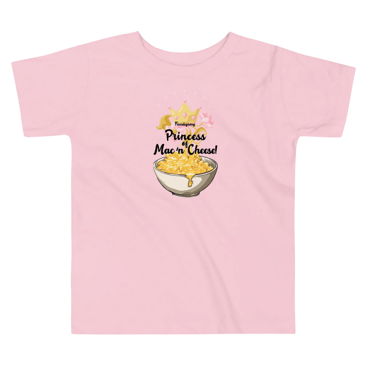 A light pink short-sleeve t-shirt with a graphic on the chest that reads 'Friendsgiving Princess of Mac 'n' Cheese!' above an illustration of a bowl of macaroni and cheese with a gold crown.