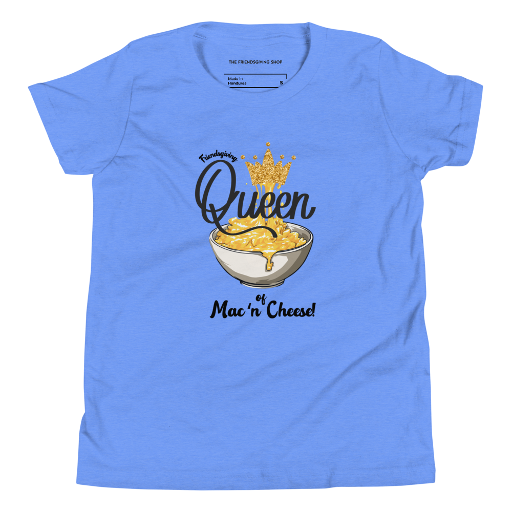 A light blue short-sleeve t-shirt with a graphic print of a bowl of cheese macaroni topped with a gold crown, accompanied by the text 'Queen of Mac 'n Cheese!'. The inner collar label shows the brand 'The Frenchy Shop'.