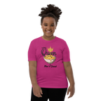 A smiling young girl with her hair in a high ponytail models a bright pink t-shirt. The t-shirt features a graphic of a bowl of cheese dip with a gold crown and the text 'Queen of by Mac 'n Cheese'.