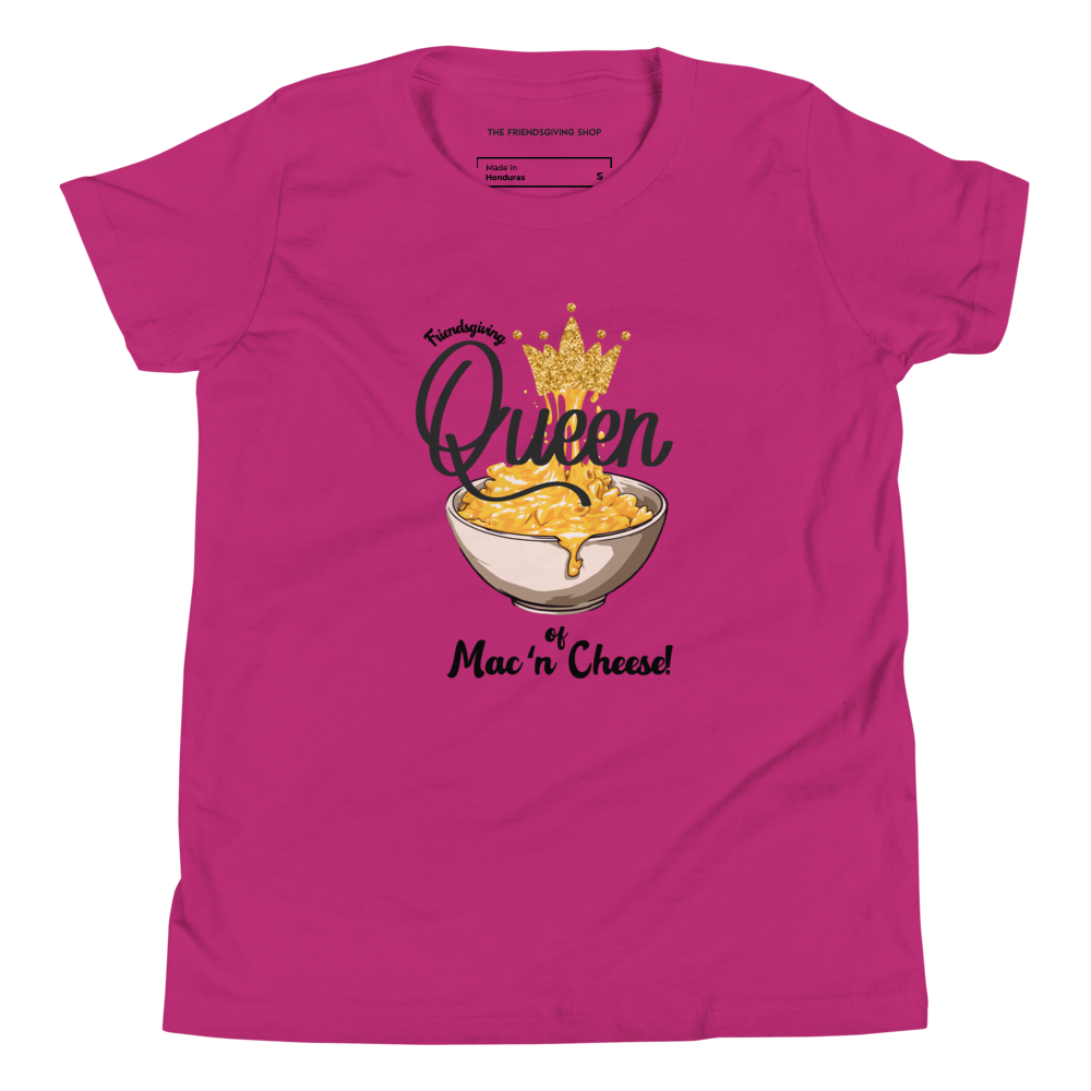 A bright pink short-sleeve t-shirt with a graphic print of a bowl of mac and cheese topped with a gold crown and the text 'Queen of Mac 'n Cheese!'.