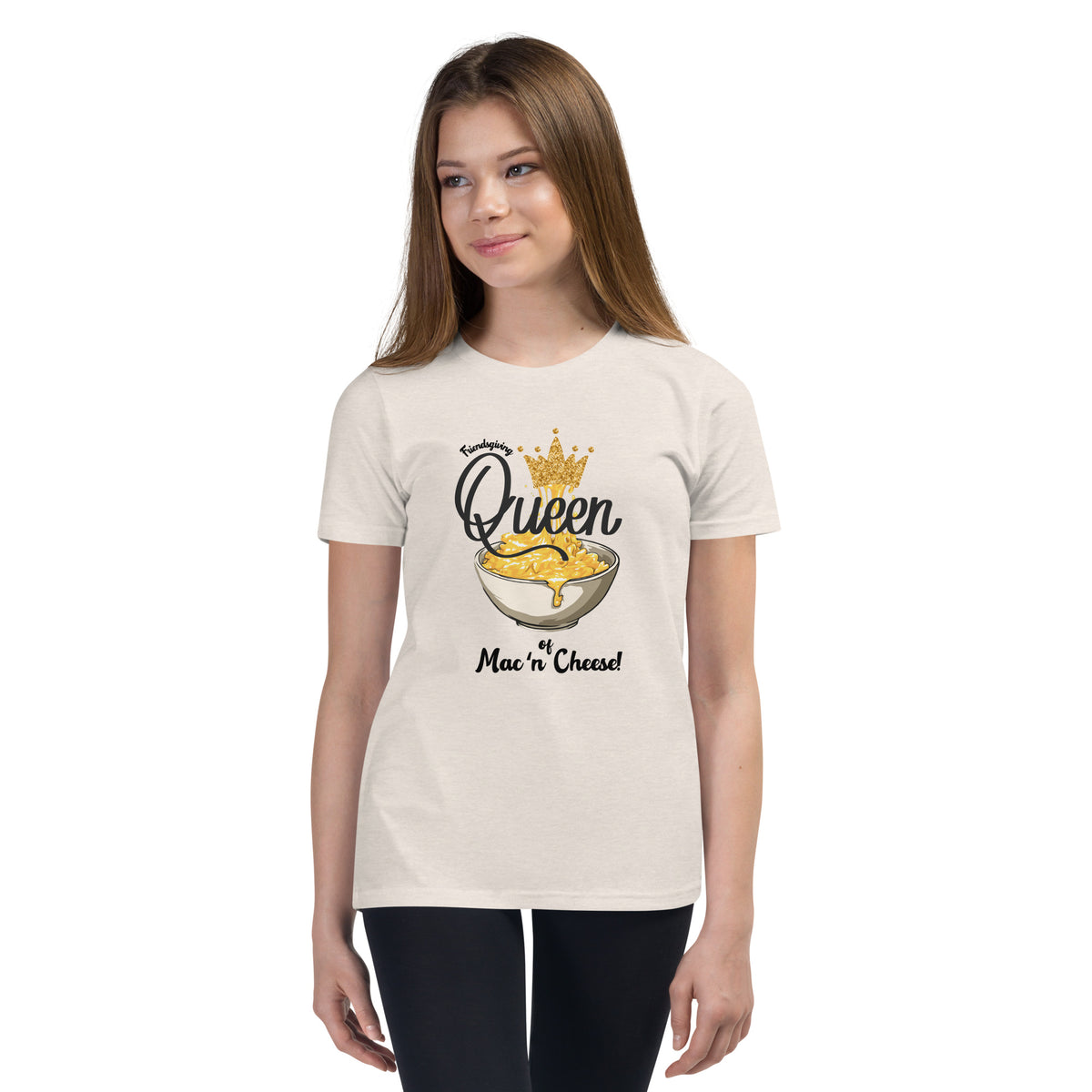 Young girl wearing a heather dust  t-shirt with a colorful mac n cheese design on a white background