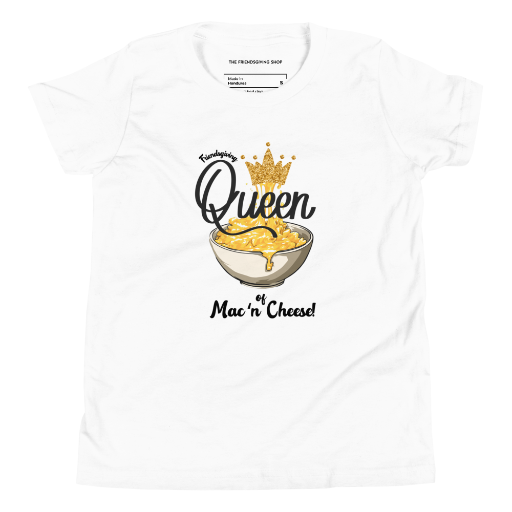 A white short-sleeve crewneck t-shirt featuring a graphic print of a bowl of mac and cheese topped with a gold crown, with the text 'Queen of Mac'n Cheese!' printed on the front.