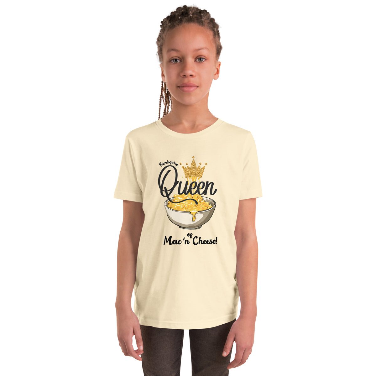 Child wearing a cream t-shirt with 'Queen of Mac n Cheese' graphic design on a white background