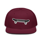 A maroon flat-brim snapback cap featuring an embroidered black skateboard with white wheels and the text 'Friendsgiving' on the front.