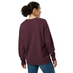 A woman shown from the back wearing a heathered burgundy crewneck sweatshirt and blue jeans against a plain white background.