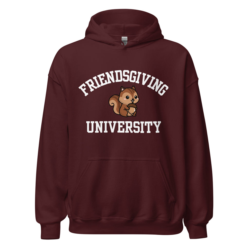 A maroon pullover hoodie with a front kangaroo pocket and a graphic on the chest that reads 'FRIENDSGIVING UNIVERSITY' in white arched text, with a cartoon squirrel in the center.