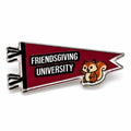 A pennant-shaped enamel pin with a dark red background and silver metal outline. The pin features the text 'FRIENDSGIVING UNIVERSITY' in white letters on black bars, with a small cartoon squirrel on the bottom right.