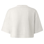 A cropped short-sleeve t-shirt shown from the back, in a light off-white or cream color, displayed on a solid white background.
