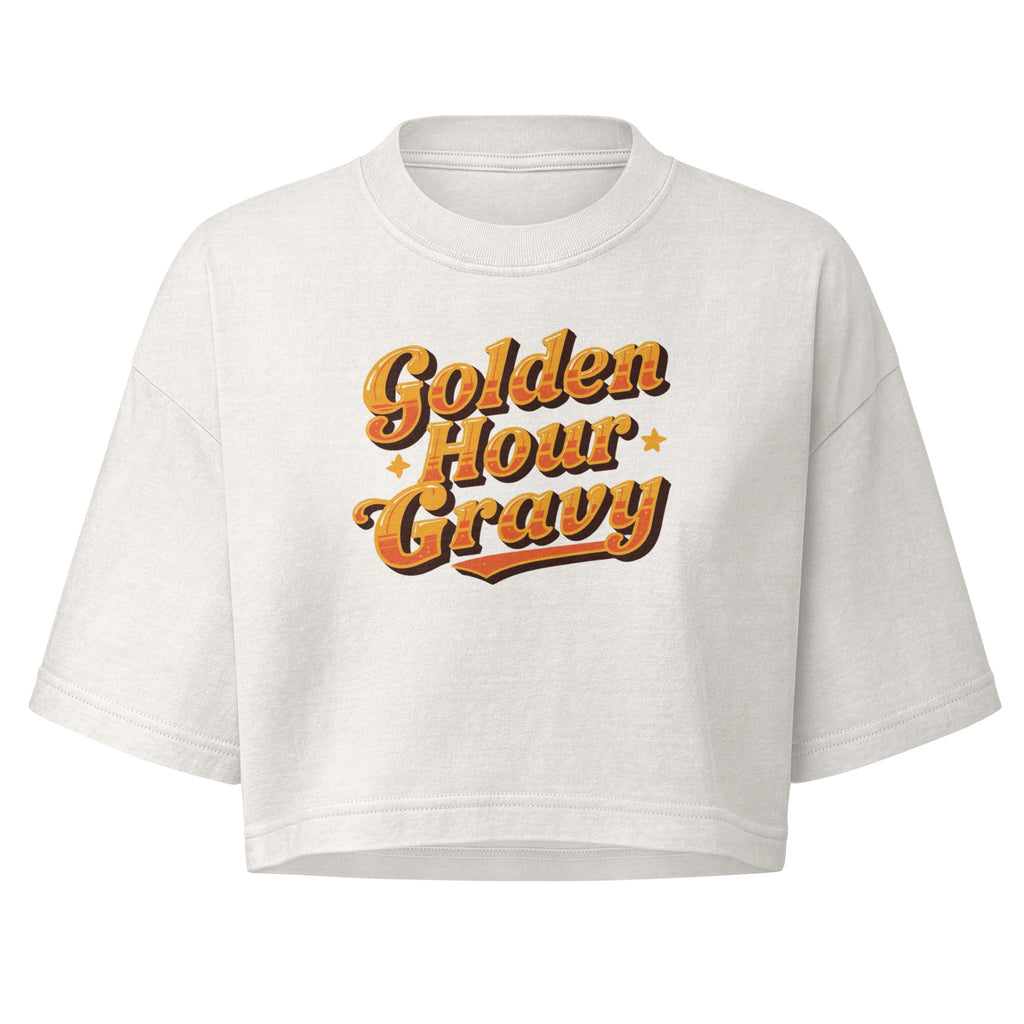 A white cropped t-shirt with a retro-style orange and yellow graphic reading 'Golden Hour Gravy' on the chest, displayed against a solid white background.