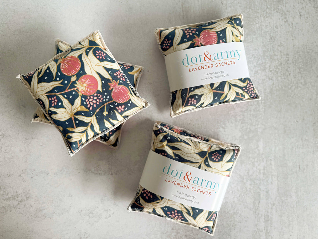 Three floral-patterned lavender sachets with 'dot&ramy' branding on a gray surface.