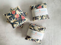 Three floral-patterned lavender sachets with 'dot&ramy' branding on a gray surface.