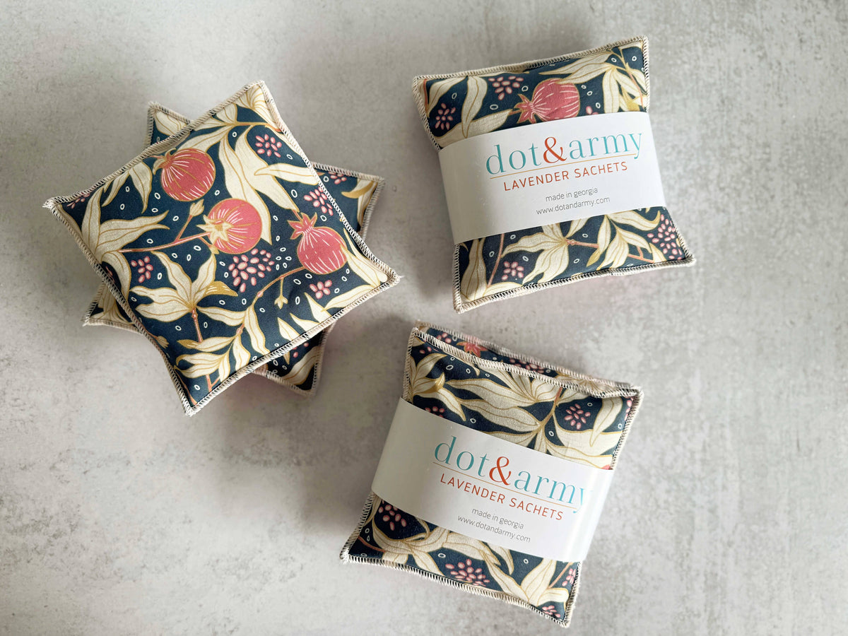 Three floral-patterned lavender sachets with 'dot&ramy' branding on a gray surface.