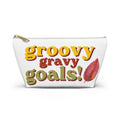 A white canvas cosmetic pouch with a gold zipper, featuring the text 'groovy gravy goals!' in yellow, red, and olive green retro lettering, alongside a red autumn leaf graphic.