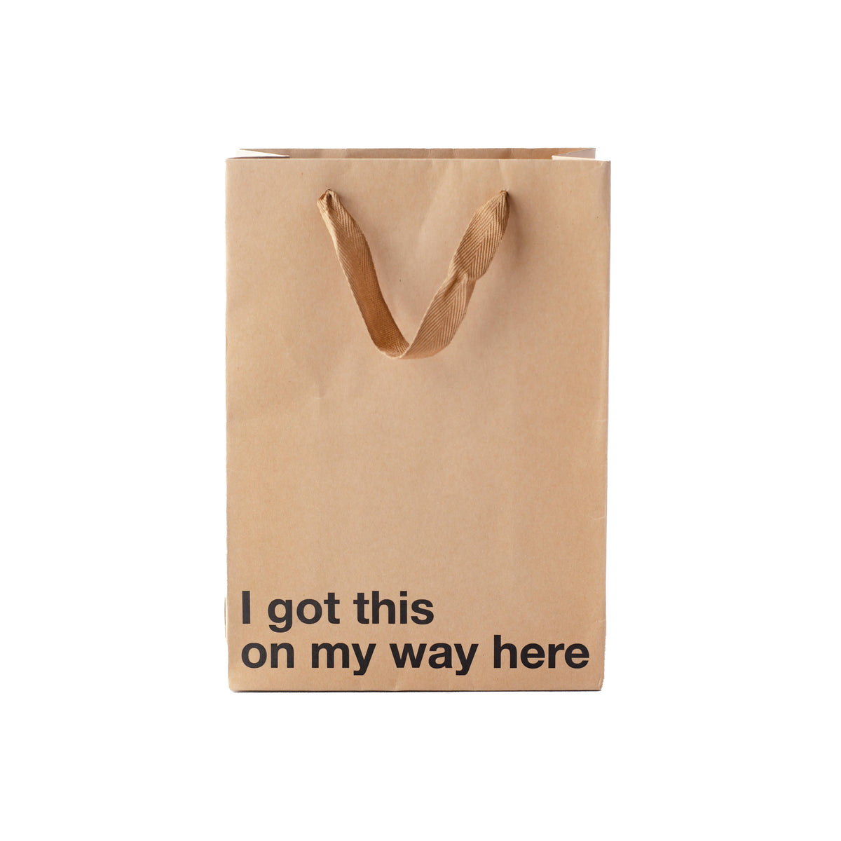 Brown paper bag with 'I got this on my way here' text on a white background