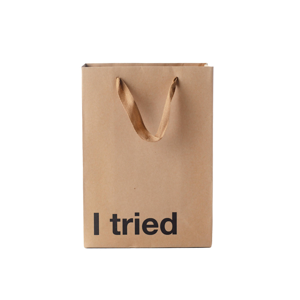 Brown paper bag with 'I tried' text on a white background