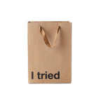 Brown paper bag with 'I tried' text on a white background
