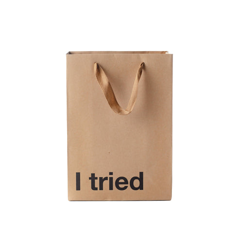 Brown paper bag with 'I tried' text on a white background