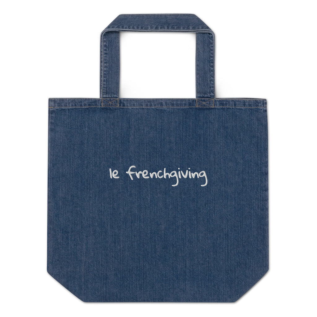 A blue denim tote bag with 'le frenchiving' embroidered in white script on the front, set against a plain white background.