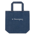 A blue denim tote bag with 'le frenchiving' embroidered in white script on the front, set against a plain white background.