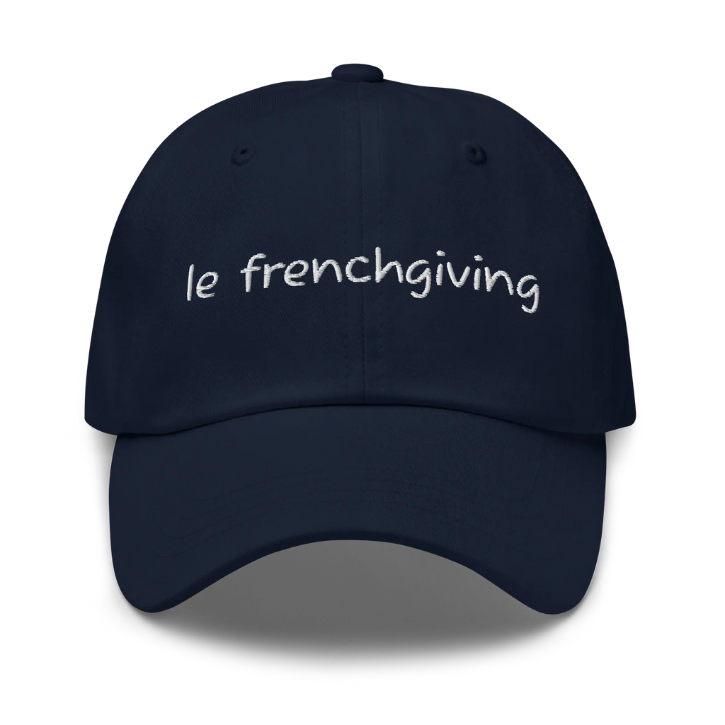 A navy blue baseball cap with 'le frenchgiving' embroidered in white script across the front, shown against a plain white background.